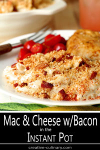 Closeup of Macaroni and Cheese with Bacon on Plate with Chicken and Sliced Tomatoes