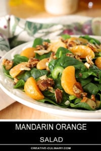 Mandarin Orange Salad with Candied Almonds Served on White Plate