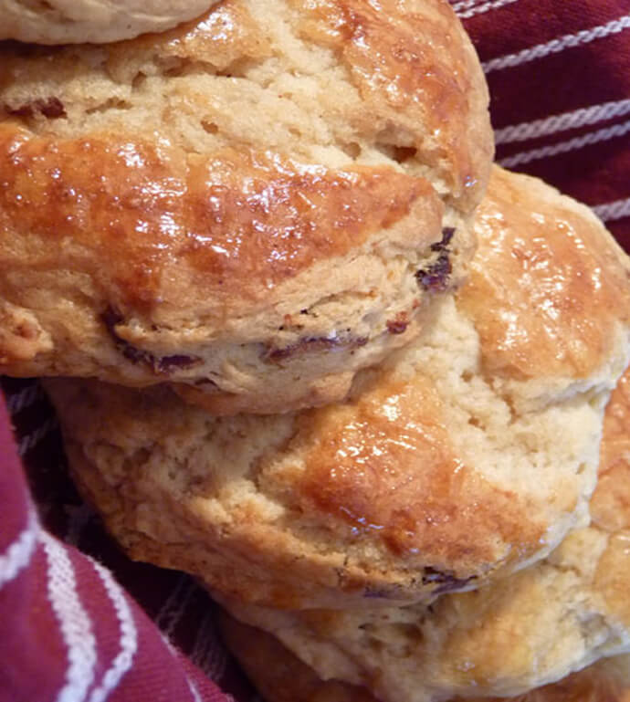 Maple Bacon Biscuits from the Huckleberry Cafe, Nestled on a Burgundy and White Kitchen Towel