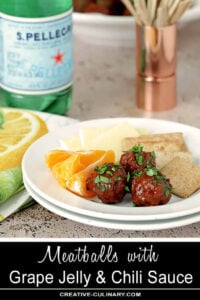 Serving of Meatballs with a Grape Jelly and Chili Sauce on a White Plate with Oranges, Cheese, and Crackers