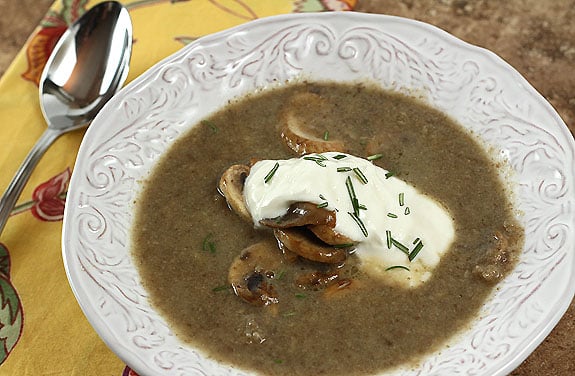 Paris Mushroom Soup in a White Bowl Garnished with Sour Cream and Chives