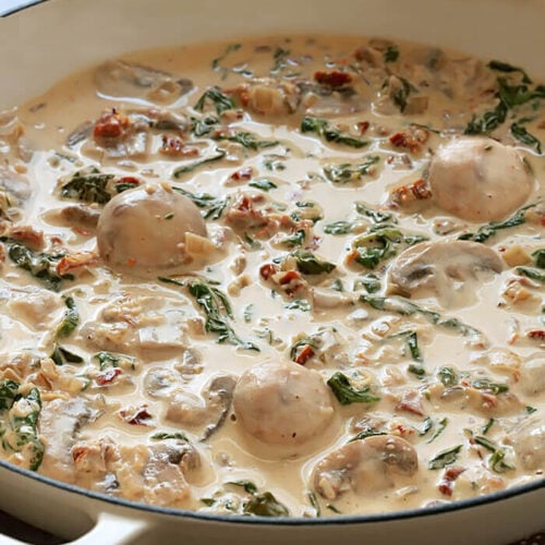 Creamy Mushroom Sauce with Sun-Dried Tomatoes and Spinach in Offwhite Skillet