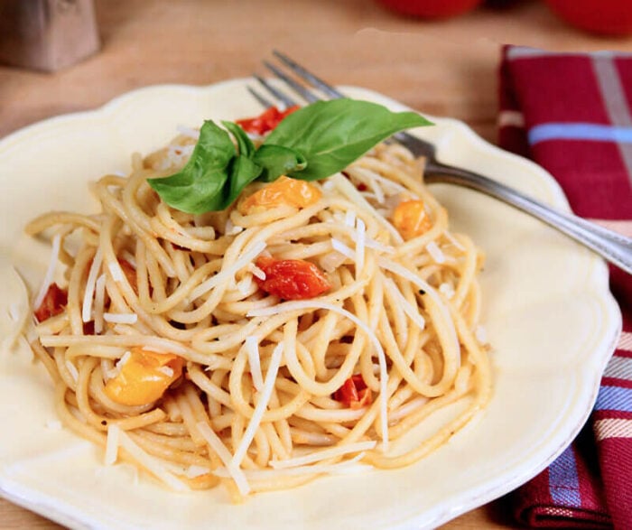 One Pot Tomato Basil Pasta Served on a White Plate and Garnished with a Basil Leaf