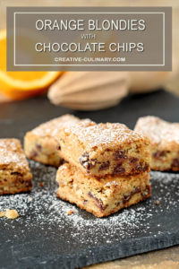 Chocolate Chip Blondies with Orange Zest Stacked and Dusted with Powdered Sugar