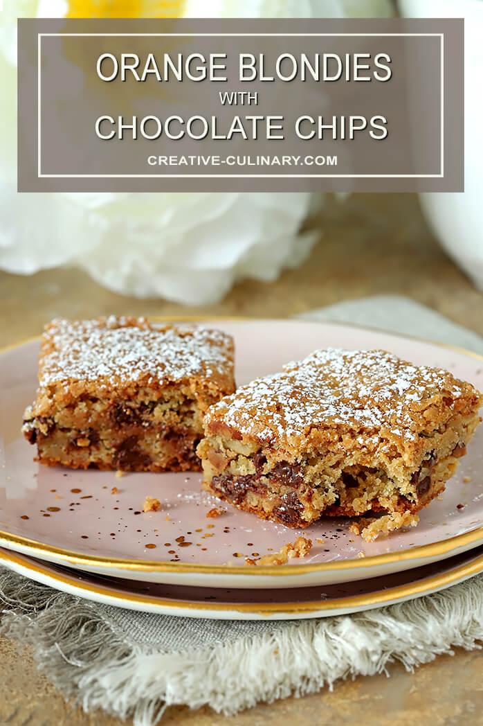 Chocolate Chip Blondies with Orange Zest on Pink Plate and Dusted with Powdered Sugar