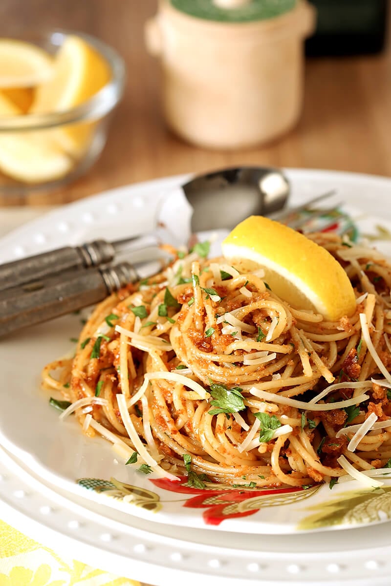 Plate of Pasta with Sun-Dried Tomato and Roasted Almond Pesto with a Lemon Garnish