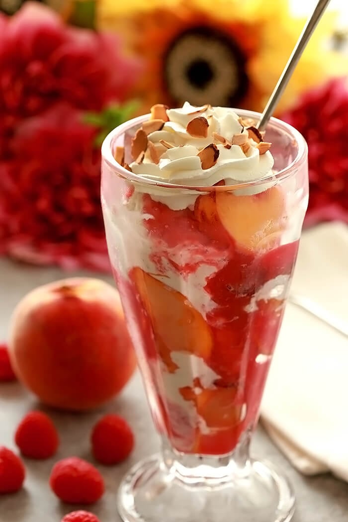 Peach Melba Ice Cream Sundae Served with Whipped Cream and Toasted Almonds