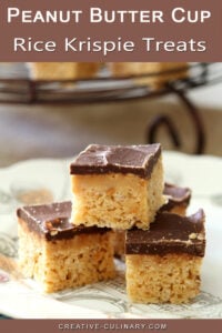 Peanut Butter Cup Rice Krispies stacked on a white plate.