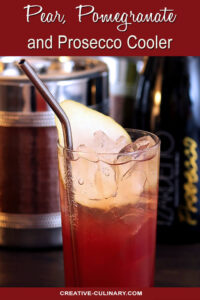 Pear Pomegranate and Prosecco Cooler in a Tall Glass with Metal Straw