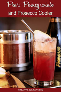 Pear Pomegranate and Prosecco Cooler in a Tall Glass with Pear Slice Garnish