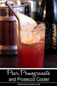 Pear Pomegranate and Prosecco Cooler in a Tall Glass with Metal Straw