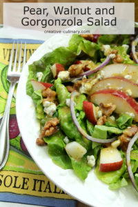 Salad with Greens, Pear, Walnuts, and Gorgonzola Cheese on White Plate