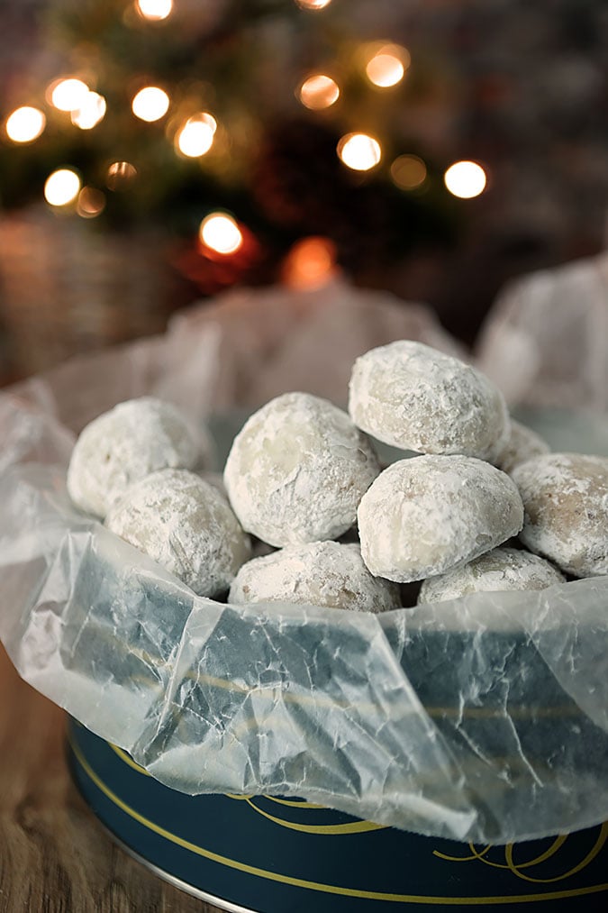 Pecan Butter Ball Cookies in a Green Holiday Tin - A shortbread cookie filled with pecans and dusted with powdered sugar.