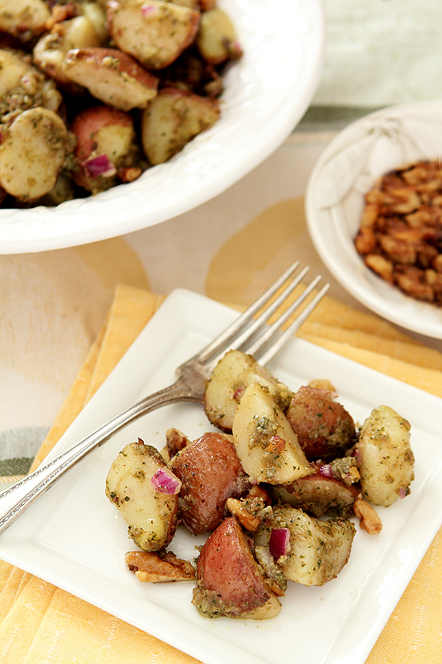 Pesto Potato Salad with Parmesan Toasted Walnuts Served on a White Square Plate