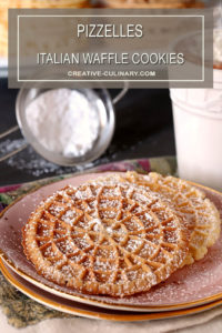 Pizzelles - Italian Waffle Cookies Sprinkled with Powdered Sugar and Served on Pink Plate