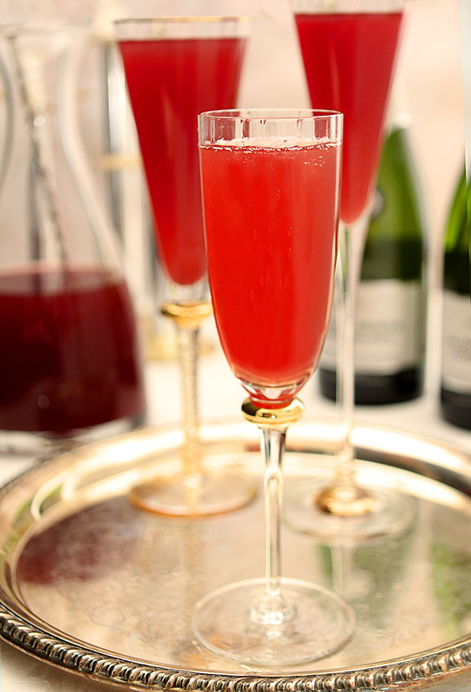 Pomegranate and Blood Orange Mimosa Cocktail Served on a Tray