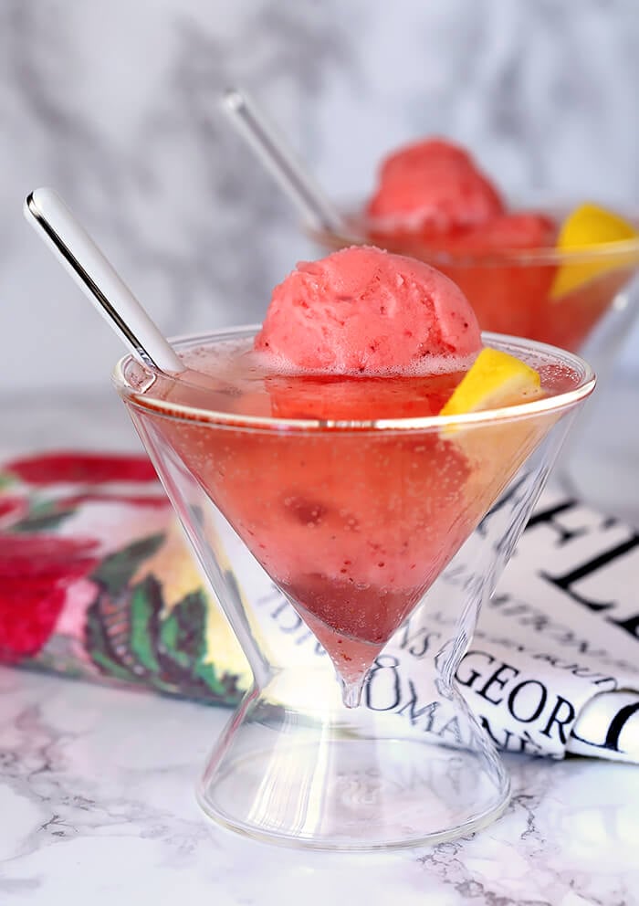 Raspberry Lemonade Wine with Sherbet Served in a Martini Glass and Garnished with Lemon