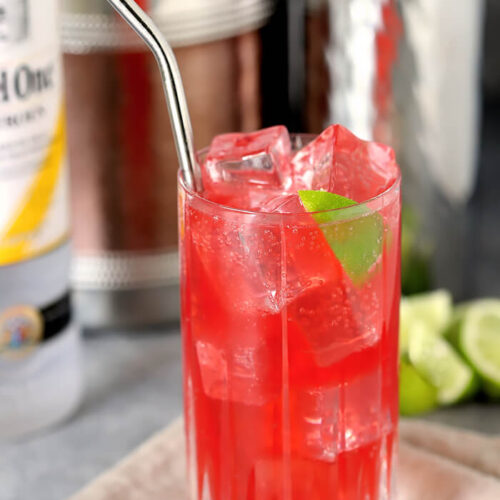 Raspberry Lime Vodka with Straw and Lime Wedge