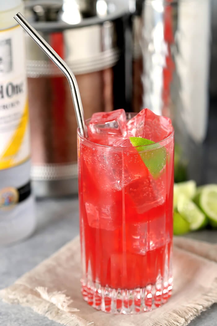 Raspberry Lime Vodka with Straw and Lime Wedge