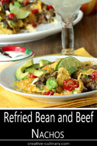 Individual Serving Plate of Refried Bean and Beef Nachos Garnished with Lime Slice