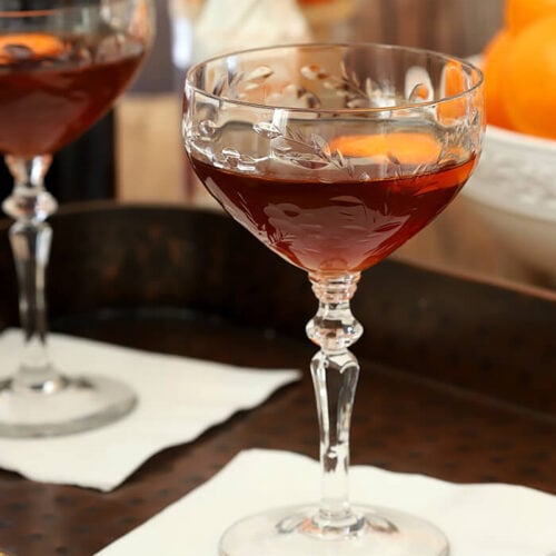 Serve the Revolver Cocktail in a Coupe Glass with a Rounded Bottom