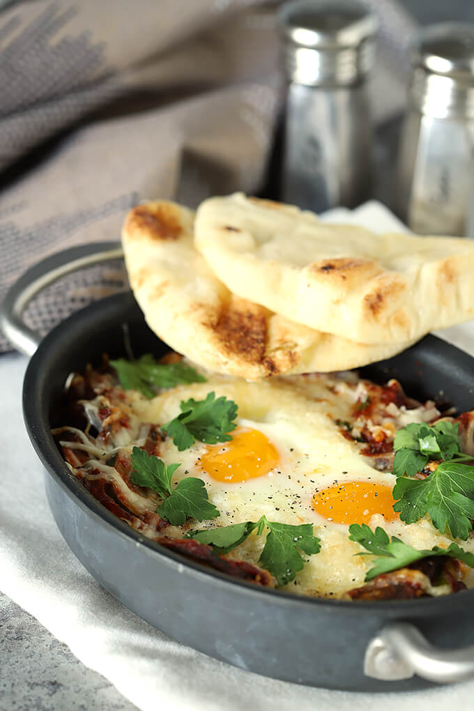 Shakshuka with Zucchini and Mushrooms In Skillet with Naan Bread