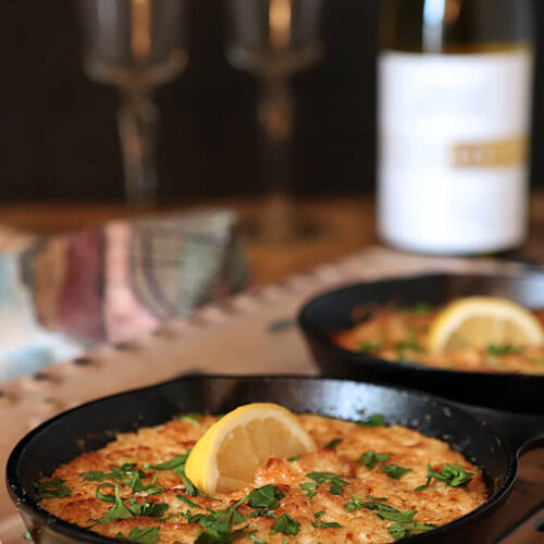 Small Cast Iron Skillets with a Shrimp Scampi and Parmesan Cheese Dip.