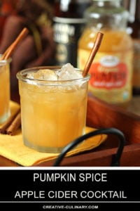 Pumpkin Spiced Apple Cider Cocktail in a Lowball Glass on a Wood and Wrought Iron Tray