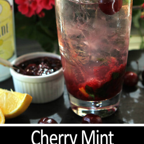 Spiked Cherry Mint Spritzer is Served in a Tall Glass with Cherry Preserves, Lemon and MInt.