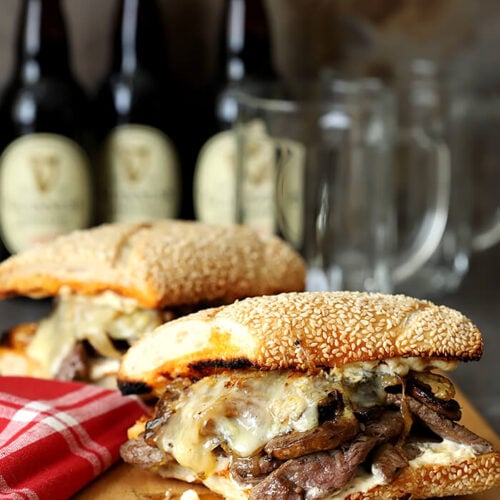 Steak and Cheese Sandwich with Caramelized Onions and Mushrooms Served on a Sesame Seed Roll