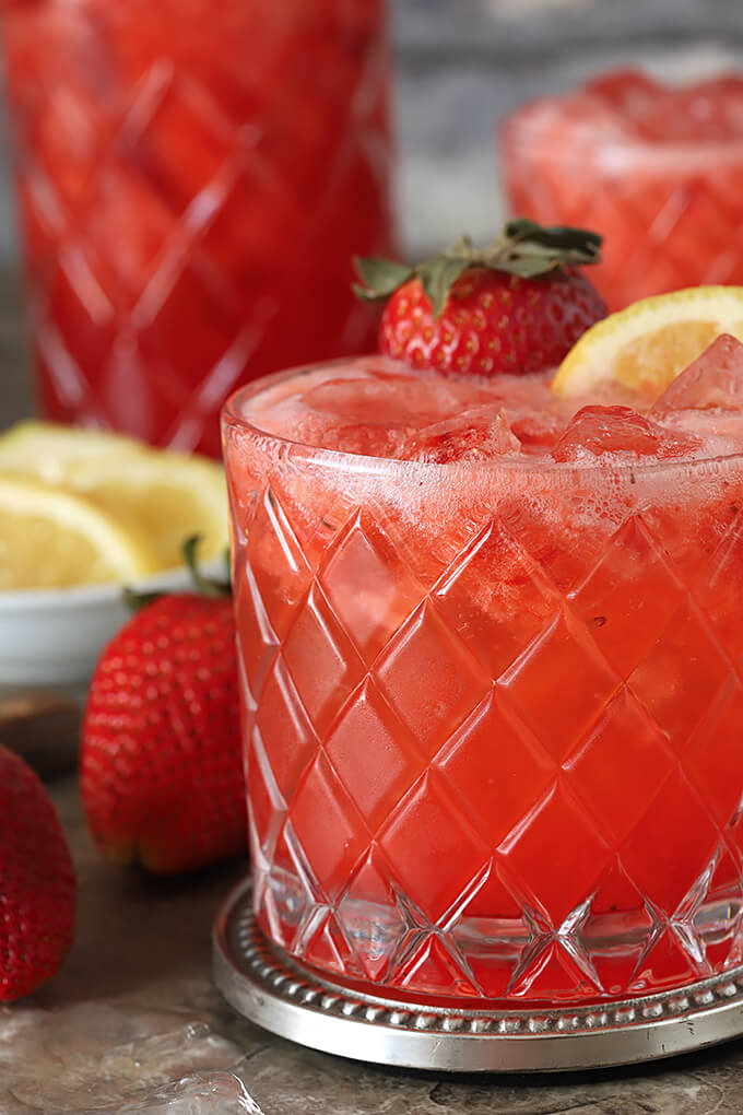 Strawberry Lemonade Fizz Cocktail with Ginger Beer Closeup in a Glass with Strawberry and Lemon Garnish