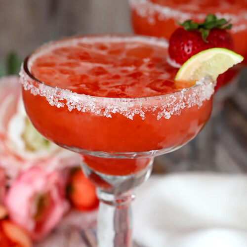 Strawberry Lemonade Margarita Garnished with a Strawberry and Lime Wedge