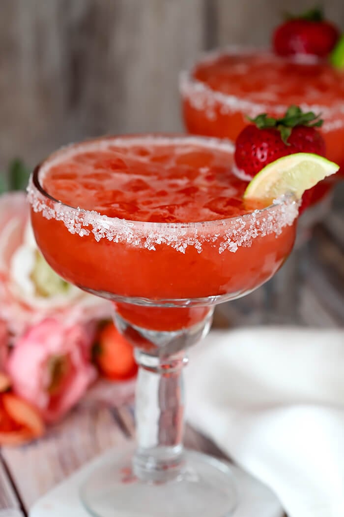 Strawberry Lemonade Margarita Garnished with a Strawberry and Lime Wedge