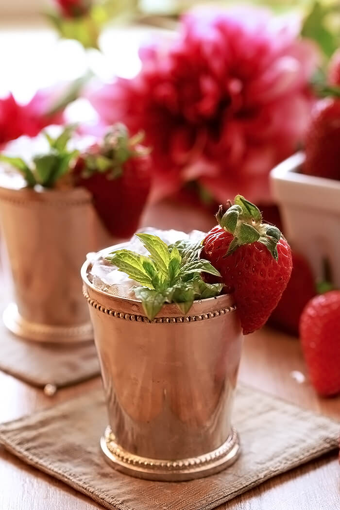 Strawberry Mint Julep Cocktail in Silver Cup with Strawberry and Mint Garnish