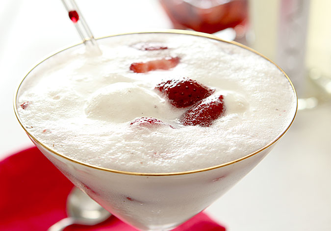 Strawberry Prosecco Float Cocktail closeup of vanilla ice cream and strawberries in gold rimmed martini glass.