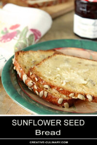 Buttered Slices of Sunflower Seed Bread on Green Plate