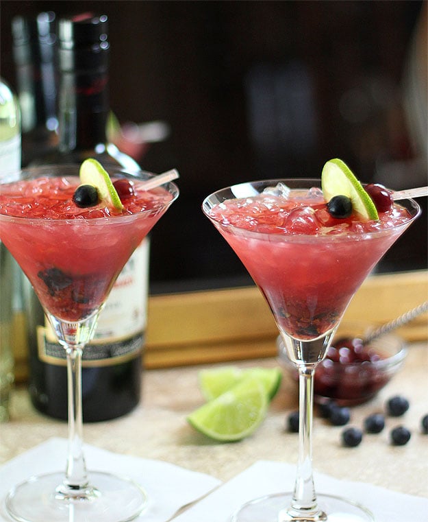 Tequila Smash Cocktails garnished with blueberries and lime wheels.