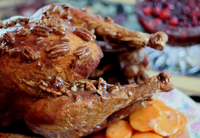 Fried Turkey with Honey, Bourbon, and Pecan Sauce Whole on a Platter with Carrots