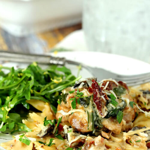 Chicken with Mushrooms, Sun-Dried Tomatoes, and Spinach in a Cream Sauce over Noodles