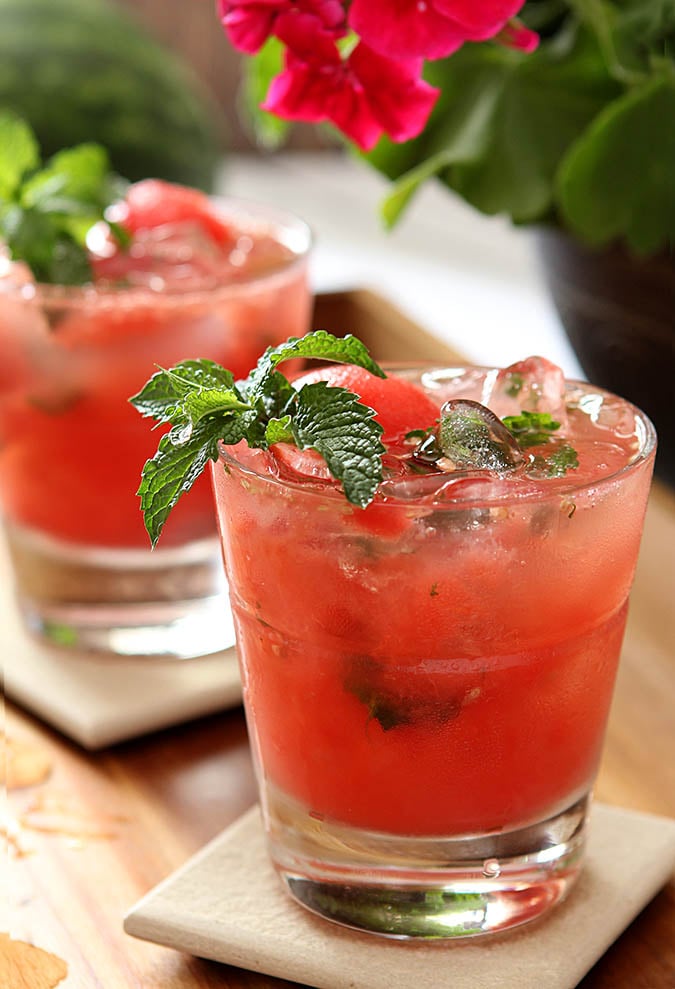 Watermelon Mint Mojito Cocktails are served in lowball glasses and garnished with mint.