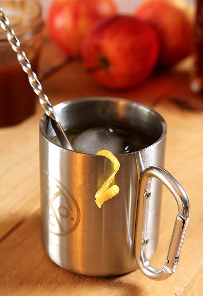 Whiskey and Cider Syrup Cocktail in a Tin Cup with Lemon Twist